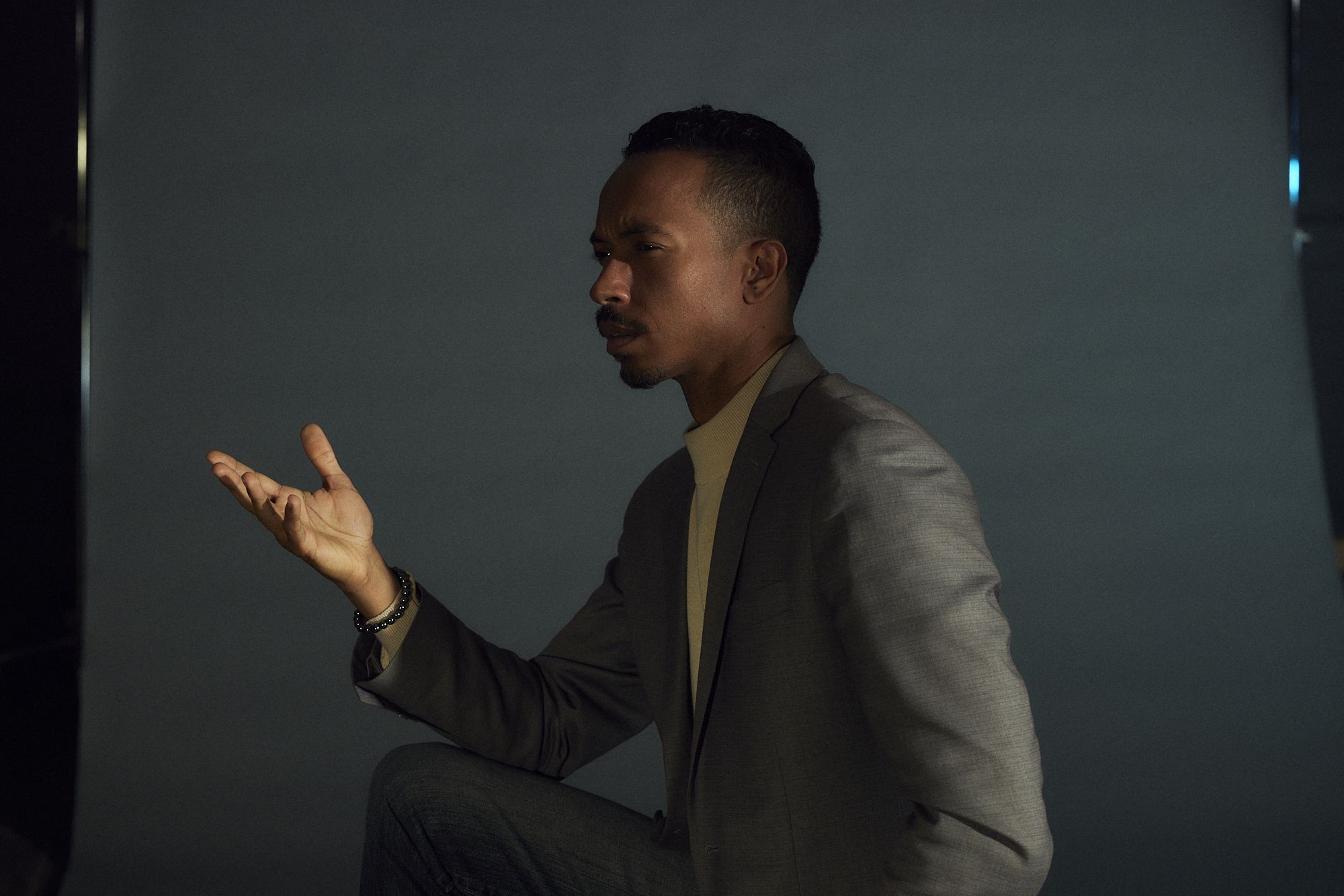 John Wood Jr. in profile, gesturing as he speaks