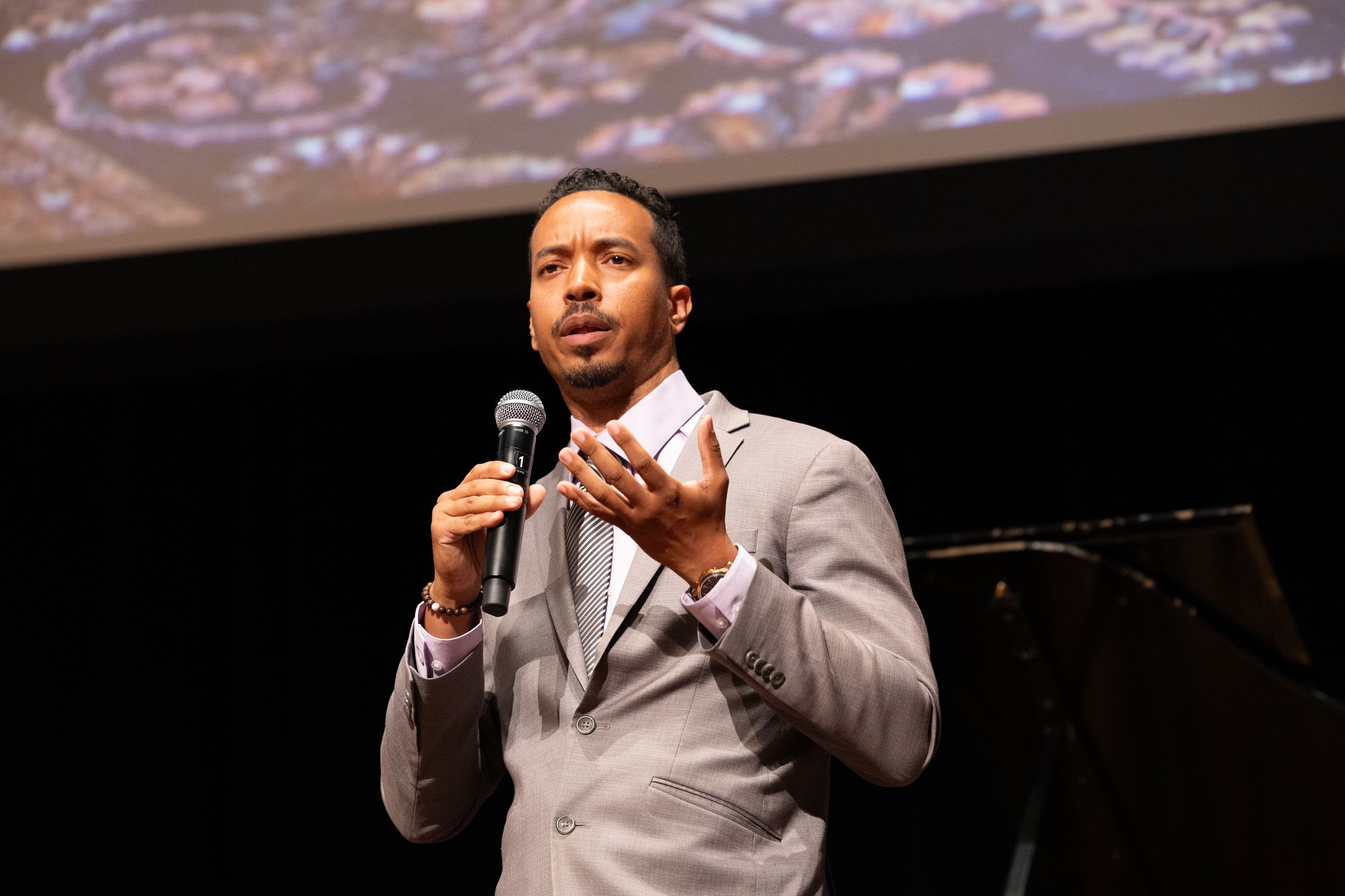 John Wood Jr. speaking on stage with a microphone